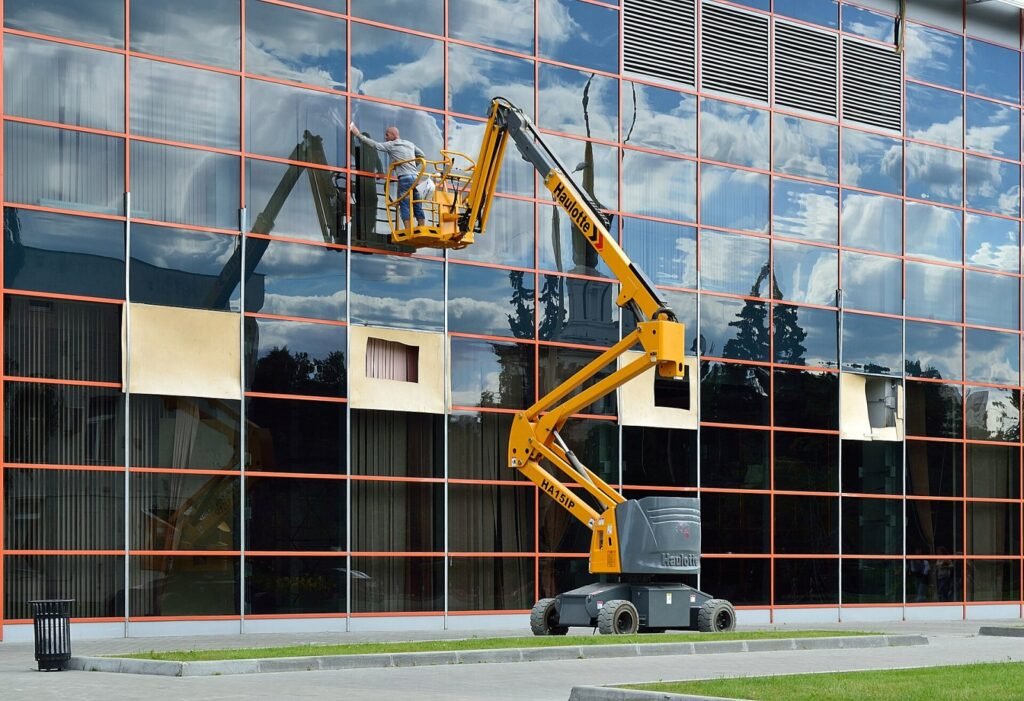 Moscow. VDNKh (the Exhibition of Achievements of the People's Economy). A window cleaner using a Haulotte HA15IP articulated boom lift (Haulotte Group