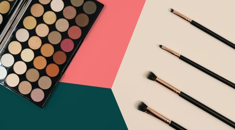 In this photo a large eyeshadow palette and set of eyeshadow brushes and eyeliner brushes can be seen in preparation for a makeover. We've decided to